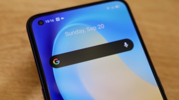 An Android phone with a Google search bar in focus