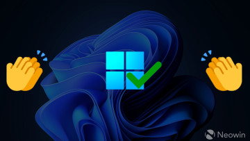 Windows 11 logo with a green check mark on it with clapping emojis on the sides