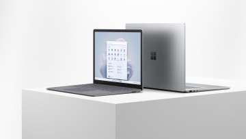 Surface Laptop 5 135 and 15 inch models with their backs against each other