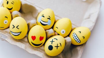 Yellow painted eggs with various facial expresssions